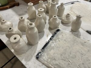 clay wrapped bud vases, drying on counter