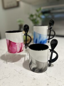 hydro-dipped black and white mugs with spoons in handles