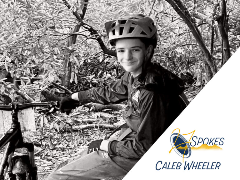 Caleb Wheeler headshot, wearing bike helmet, smiling beside his bike; 27 Spokes logo; Caleb Wheeler